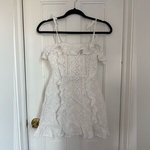 White eyelet mini dress with ruffles. Perfect graduation dress.  Size XS.
